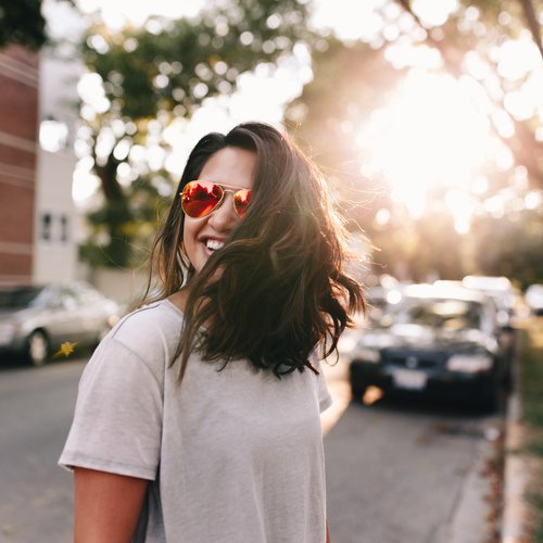 A happy woman wearing sun glasses