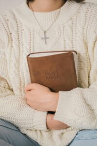 woman holding Bible to her chest