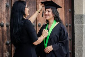 mom adjusting daughter's graduation cap